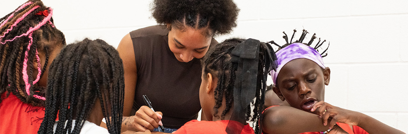 Hannah Stuelke singing autographs for students