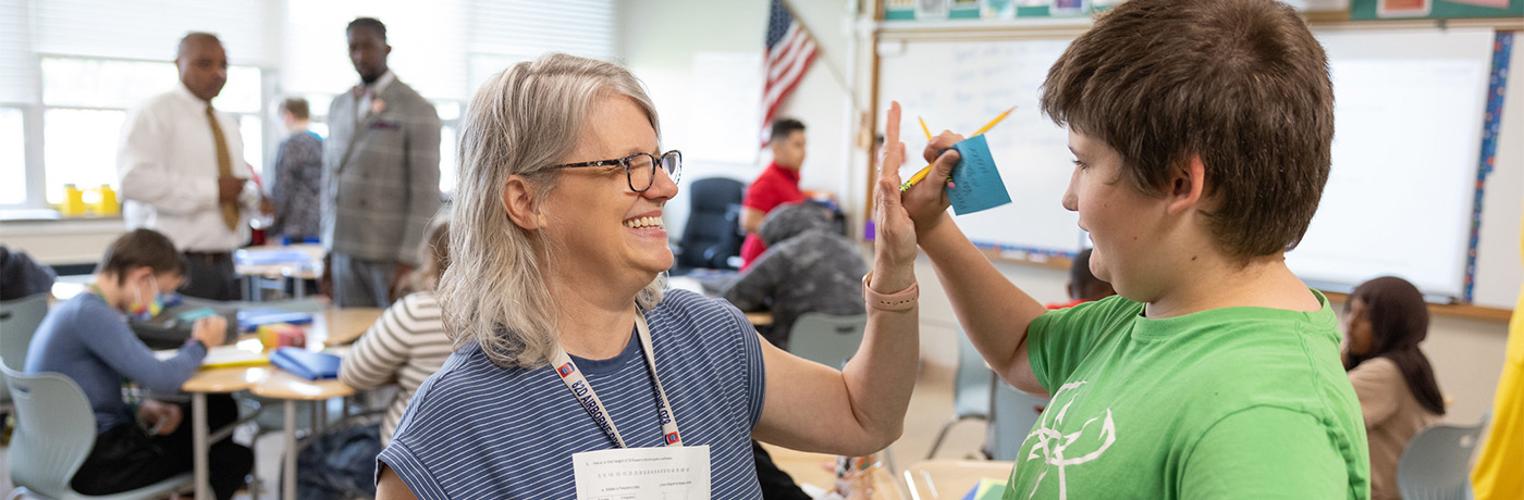 teacher and student high fiving